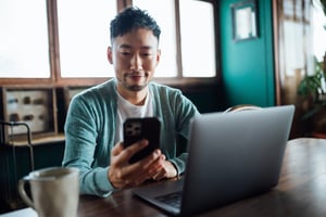 Man looking at his phone and smiling
