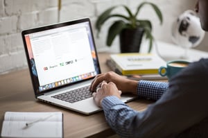 Person at a desk working on a laptop