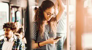 Woman on bus looking at her phone